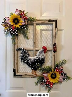 a rooster and sunflower wreath on the front door of a house with an old window