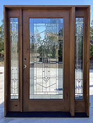 a wooden door with glass panels on the front and side doors, in an empty lot