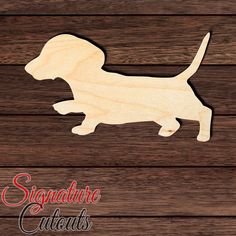 a wooden cutout of a dog sitting on top of a wooden floor with the words signature cuts