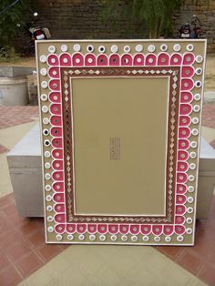 a mirror sitting on top of a tiled floor