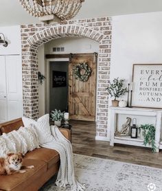 a living room filled with furniture and a wooden door in the middle of it's wall