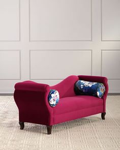 a red chair sitting on top of a carpeted floor next to a white wall