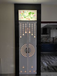 the door is decorated with flowers and bells on it's sides, along with other decorations