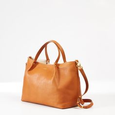 From a busy work life to a leisure time getaway, this luxe tote will quickly become your go-to bag. Beautiful and durable, made from high-quality Italian leather, it includes magnetic closure, a flat bottom that allows it to sit up, both handles and a detachable crossbody strap and three interior pockets. A foil debossed monogram finishes this go-to bag for special holidays or every day.  13.5" w x 6" d x 10" h  Handle drop: 5"; Detachable strap: 36" - 40"  Two interior open pockets. Open: 5.25" Luxury Shoulder Bag With Handles For Everyday, Modern Everyday Crossbody Satchel, On-the-go Satchel With Leather Handles, Luxury Satchel With Rolled Handles For On-the-go, Everyday Luxury Satchel With Handle Drop, Everyday Satchel With Detachable Top Handle, Everyday Satchel With Double Handle, Modern Bucket Bag With Leather Handles For On-the-go, Everyday Leather Satchel With Top Handle