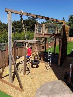 a child playing on a wooden swing set