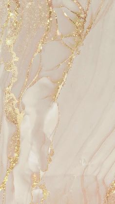 an abstract marble background with gold paint and glittery streaks on the top half of it