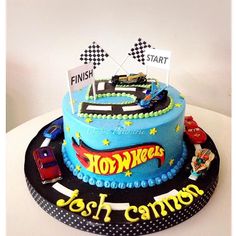 a birthday cake decorated with cars and race flags