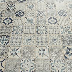 a blue and white tiled floor with different designs