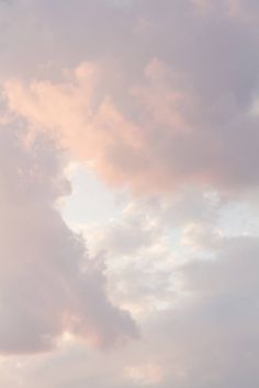 an airplane is flying in the sky with clouds behind it and one plane has just taken off