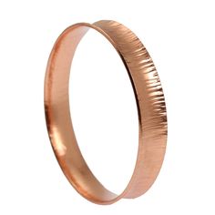 A slender bangle bracelet is a must-have for any woman's accessory collection, and the John S. Brana Chased Anticlastic Copper Bangle Bracelet is the perfect choice to complete your jewelry box or a special lady's. The styling possibilities for this chic handmade copper bangle are truly unlimited. Wear it on its own for a simple accent or purchase more than one and wear them together for a Boho beautiful layer effect. Mix and match the bangle with cuff, wrap and bangle bracelets to show off your Formal Adjustable Stackable Bangle, Rose Gold Stackable Bangle As Gift, Stackable Bracelets For Gift, Elegant Band Bracelets As Gifts, Modern Band Bracelets For Gifts, Elegant Band Bracelet For Gift, Modern Band Bracelet As Gift, Rose Gold Hoop Bracelets For Gift, Modern Band Jewelry Gift