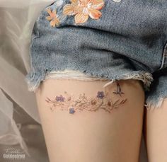 the back of a woman's thigh with flowers on it