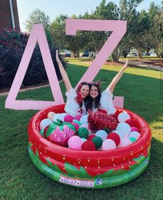 two women in an inflatable pool with the number seven