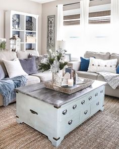 a living room filled with lots of furniture and pillows on top of a rug covered floor