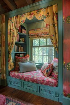 a window seat in the corner of a room with bookshelves and pillows on it