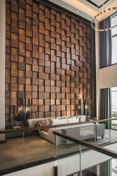 a living room filled with lots of furniture and walls covered in wooden panels on the wall