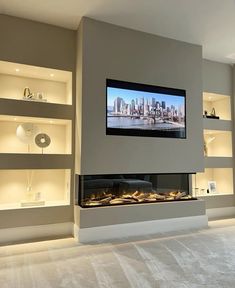 a flat screen tv mounted to the side of a wall next to a fire place