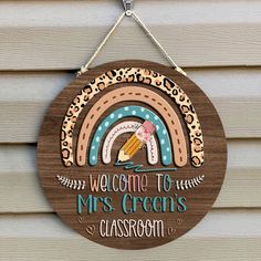 a welcome to mrs green's classroom sign hanging on the side of a house