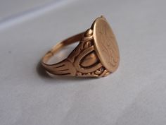 Victorian Ostby Barton Signet Ring 10k Yellow Gold.  This handsome guy weighs 3.7g, the setting measures 14.5mm tall (North to South) and he is currently a size 9. He has a nicely aged rosy gold patina that I have left as found as well as a cut band..an easy fix for your local jeweler or for future sizing.  Striking piece to add to an Ostby Barton collection. (Sadly, the maker, Ostby, perished on the Titanic in 1912).  All items are in previously loved, used condition so please review all photos Gift Ring With Maker's Mark, Oval Ring With Maker's Mark For Gift, Victorian Etched Ring Jewelry, Victorian Style Etched Ring Jewelry, Antique Adjustable Etched Ring, Collectible Gold Stamped Ring, Vintage Adjustable Engraved Initial Ring, Antique Adjustable Etched Rings, Adjustable Vintage Engraved Initial Ring