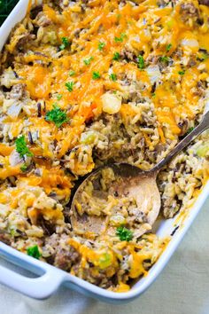 a casserole dish with sausage, rice and broccoli