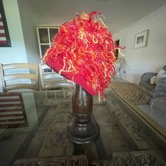 a red hat is sitting on top of a table in a room with other furniture