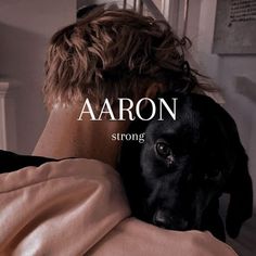 a black dog laying on top of a person's back with the caption aaron strong