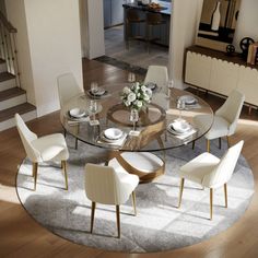 a round glass table with white chairs and plates on it in the middle of a living room