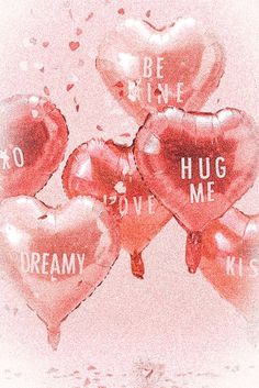 red heart shaped balloons with the words be mine, hug me, and dream written on them