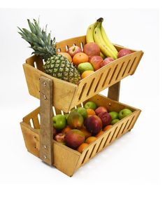 two wooden baskets filled with assorted fruit on top of each other in front of a white background