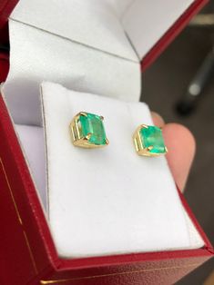 Featured here is a beautiful set of emerald cut Colombian emerald studs in fine 14K yellow gold. Displayed are medium-green emeralds with very good transparency, accented by a simple four-prong 14K gold mount, allowing for the emerald to be shown in full view. The earth mined, green Colombian emeralds have a desirable lush green color with excellent qualities. These earrings are ideal for everyday use and are the perfect accessory to any outfit. Total Carat Weight: 2.0cts Setting Style: Four Pro Green Baguette Cut Earrings For Gifts, Baguette Cut Emerald Earrings As A Gift, Emerald Cut Green Gemstone Earrings, Emerald Cut Green Earrings, Fine Jewelry Emerald Cut May Birthstone Earrings, Fine Jewelry Baguette Cut Emerald Earrings, Fine Jewelry Emerald Cut Earrings For May Birthstone, May Birthstone Emerald Cut Fine Jewelry Earrings, Emerald Cut Gemstone Earrings In 14k Gold