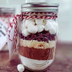 a mason jar filled with marshmallows and chocolate