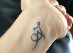 a person with a tattoo on their wrist