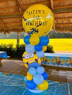 a birthday cake made out of balloons on top of a table