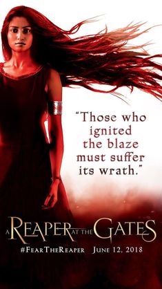 a woman with long red hair standing in front of a poster for the movie reaper gates