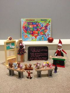 a group of toys sitting on top of a carpeted floor next to a chalkboard