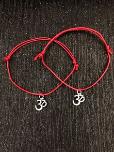 A duo set of Kabbalah charm bracelets. One for you and someone else 💕 Make your choice from either the 2 lotus charms, 2 Buddha charms or the 2 om charms. Just make selection from drop down box. All sets feature a Tibetan silver charm, thread on a red waxed cord. These bracelets are fully adjustable so will fit on any sized wrist. Just slip on wrist and adjust accordingly.  Bracelets will be carefully placed in little black organza gift bags and sprinkled with star confetti then packed in a Jiffy bag. All ready to give as a gift. Try to not bathe with your new bracelets and if possible avoid direct contact with lotions and perfumes. Kabbalah bracelet, red string bracelet, lotus bracelet, buddha bracelet, om bracelet, ohm bracelet, namaste gifts, wax cord bracelets, yoga Ohm Bracelet, Om Bracelet, Kabbalah Bracelet, Sterling Silver Heart Bracelet, Wax Cord Bracelet, Lotus Bracelet, Om Charm, Buddha Bracelets, Red String Bracelet