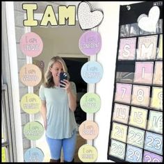 a woman taking a selfie in front of a mirror with magnets on it