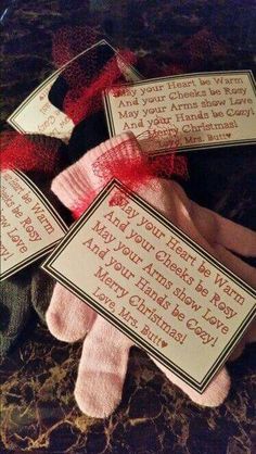 three pairs of pink socks with red bows on them and some cards in the middle