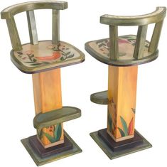 two wooden chairs sitting next to each other on top of pedestals with designs painted on them