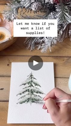 someone is painting a christmas tree with watercolors on paper and then it's written