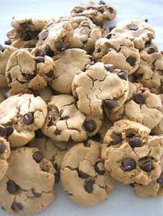 a pile of chocolate chip cookies sitting on top of a table