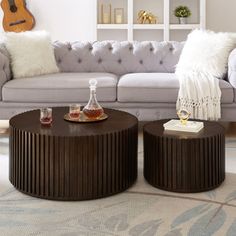 a living room filled with furniture and a guitar on top of a table in front of a couch