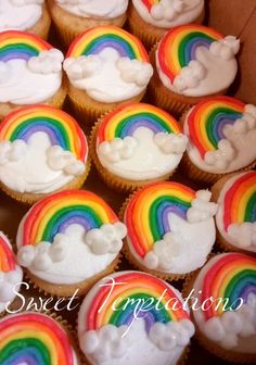 cupcakes with white frosting and rainbow decorations