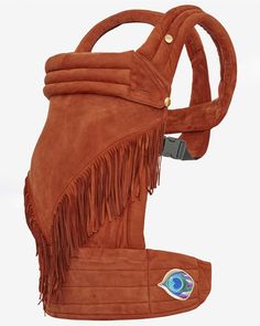 a brown leather purse with fringes on the sides and an eye in the center