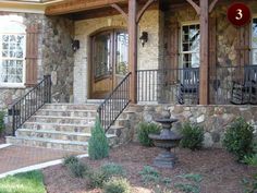 a stone house with steps leading up to the front door