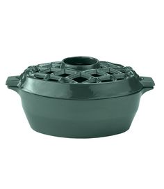 a green cast iron casserole on a white background