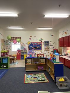 a child's playroom with toys and desks