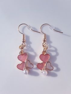 Valentines Day Pink Heart Earrings These earrings are great for this Valentines day. They have 3 hearts. 2 of them are pink and the right one is hollow. At the bottom the the earring it has a tiny white pearl. I think these earrings are really pretty and great gift for anyone.  The back of the earrings a gold. These earrings are small and light on the earrings so you wont feel them when your wearing them. Valentines Party Decor, Pink Heart Earrings, 3 Hearts, Earrings Pink, Valentines Gifts For Her, Heart Earrings, Pink Heart, Pearl White, Beautiful Necklaces