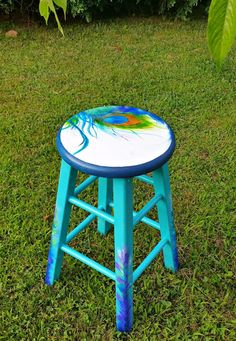 a painted stool sitting in the grass