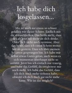 a poem written in german on the side of a road with trees and fog behind it