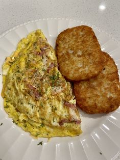 an omelet and two biscuits on a white plate